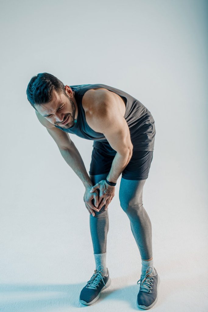 v2exhausted-sportsman-feeling-pain-knee-young-bearded-european-man-wear-sports-uniform-concept-sports-injury-isolated-turquoise-background-studio-shoot.jpg